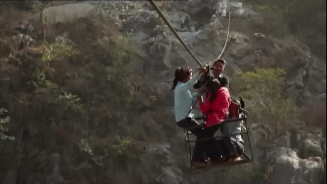 Nepalese children on cable crossing