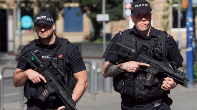 Armed police patrol near to the Manchester Arena,
