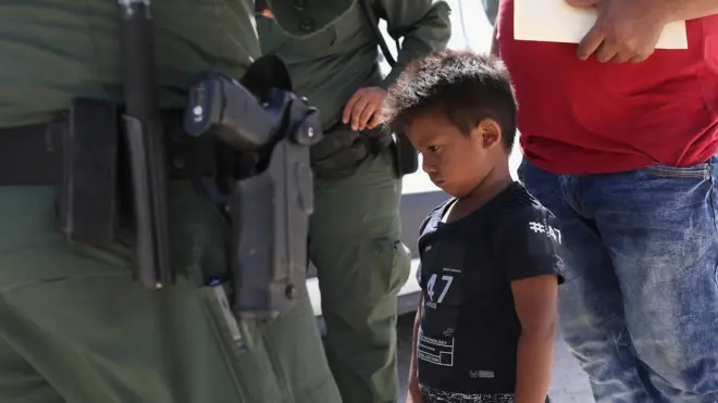 A small boy from Honduras waits as he and his father are taken into custody by U.S. Border Patrol agents near the U.S.-Mexico Border on June 12, 2018 near Mission, Texas.