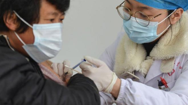 A medical worker vaccinates a rural resident at a COVID-19 vaccination site at the township level in Fuyang.