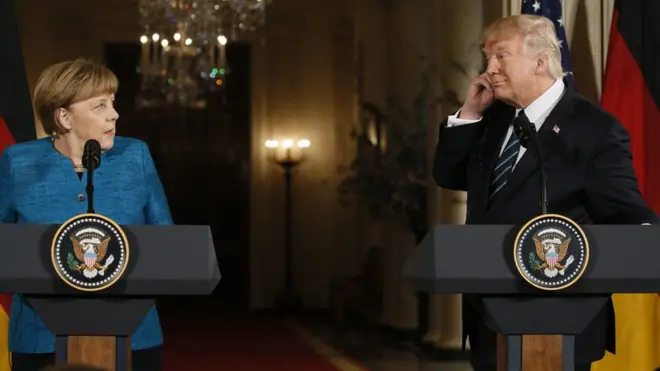 Germany"s Chancellor Angela Merkel speaks as U.S. President Donald Trump looks on during their joint news conference in the East Room of the White House in Washington, U.S., March 17, 2017