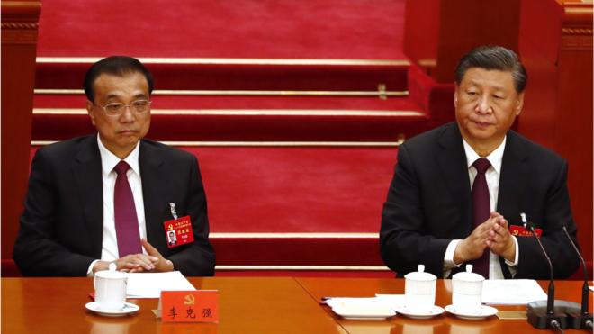 Chinese President Xi Jinping (R) reacts next to Premier Li Keqiang (L) during the closing ceremony of the 20th National Congress of the Communist Party of China (CPC) at the Great Hall of People in Beijing, China, 22 October 202