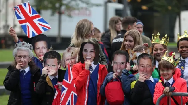 Schoolchildren greet the royal couple at the National Football Museum in Manchester
