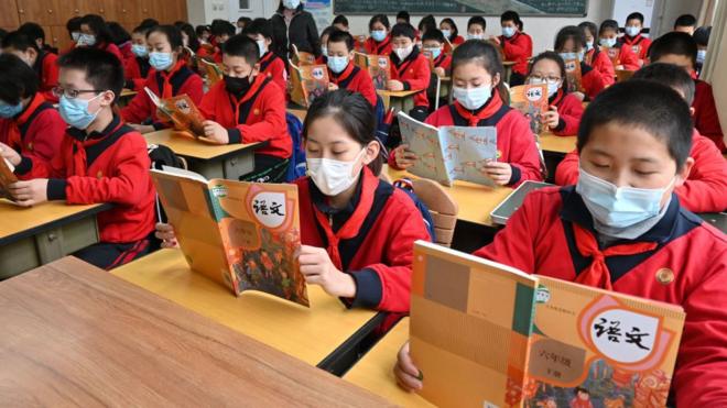 Students wearing face masks take part in a class at a primary school on March 1, 2021