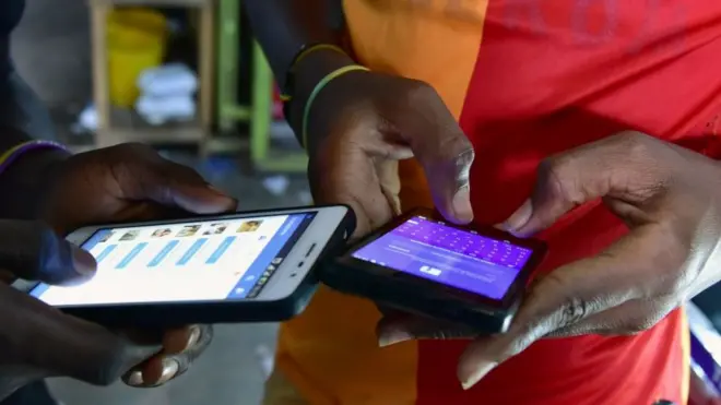 Two pairs of hands, each holding a smartphone