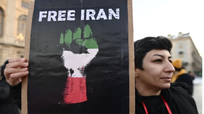 A protester in Turin, Italy holds a sign saying 'Free Iran' in support of Iranian women