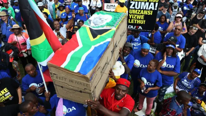 Zuma comot for power for February 2018 but im dey face 16 charges of corruption