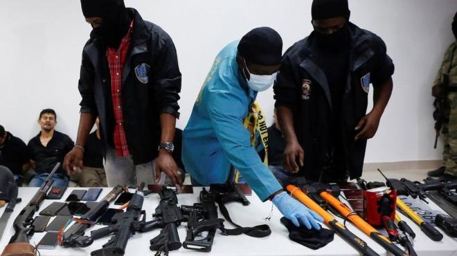 Weaponry, mobile phones, passports and other items were shown to the media along with suspects in the assassination