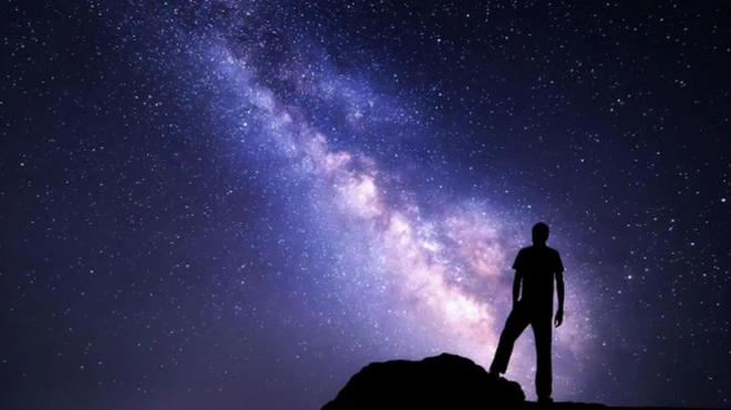 คนยืนมองกาแลกซี่บนท้องฟ้า