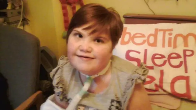 Shauna sitting on a bed