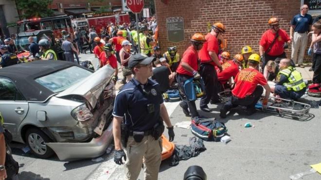 A woman is received first-aid after a car accident ran into a crowd of protesters in Charlottesville, VA on 12 August 2017.