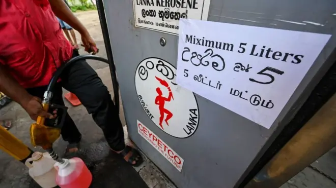 People queue up to buy kerosene for domestic use at a supply station in Colombo on May 17, 2022.