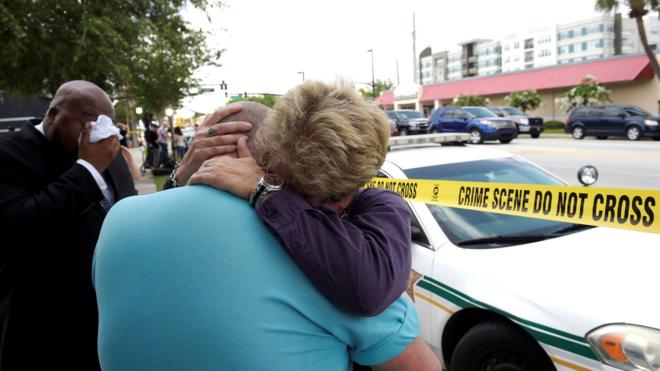 Terry DeCarlo, executive director of the LGBT Center of Central Florida, is comforted by Orlando City Commissioner Patty Sheehan - 12 June