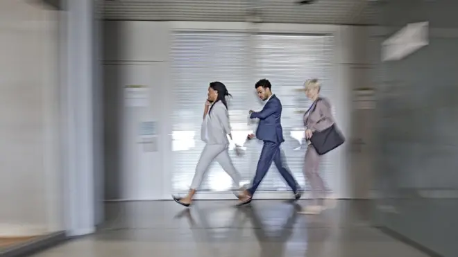 Workers walking in an office