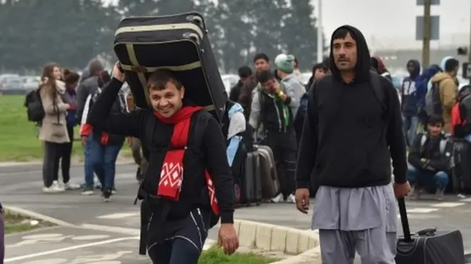 Migrants leaving the Calais camp