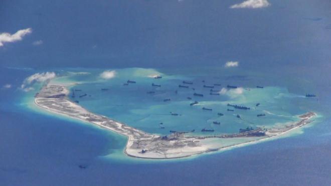 Chinese dredging vessels purportedly seen in the waters around Mischief Reef in the disputed Spratly Islands in the South China Sea in this still image from video taken by a US surveillance aircraft on 21 May 2015