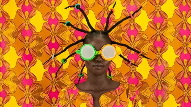 Woman disguised by colourful fabric