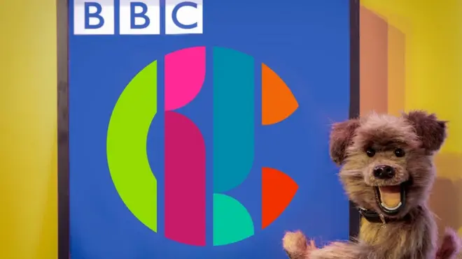 The Hacker T Dog puppet and the CBBC logo