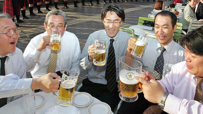 Japanese "salarymen" drinking in a rooftop beer garden in Tokyo on 3 May 2006.