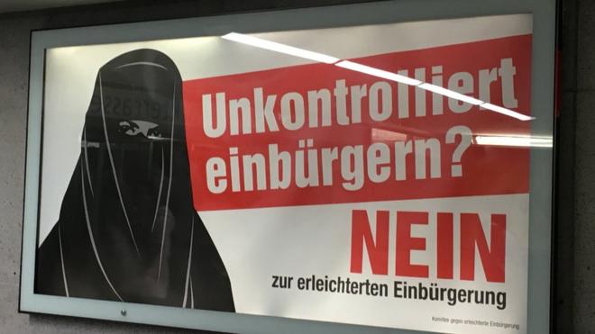 Woman in burka on poster warning against the reforms