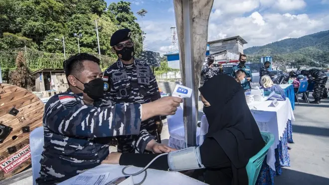 Diskes Lantamal X TNI AL mengukur suhu tubuh peserta vaksinasi Covid-19 di Dermaga Pelabuhan Jayapura, Papua, 30 Agustus lalu.