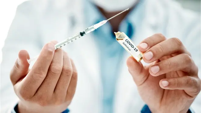 Scientist holding a Covid vaccine
