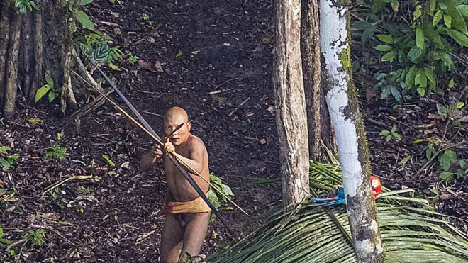 Indian aims arrow against photographer