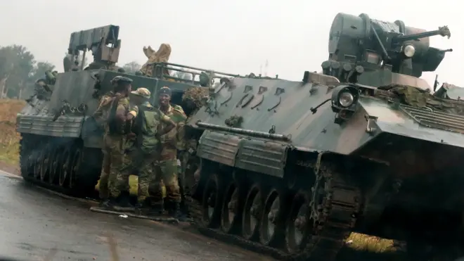Soldiers stand beside military vehicles just outside Harare, Zimbabwe, November 14,2017