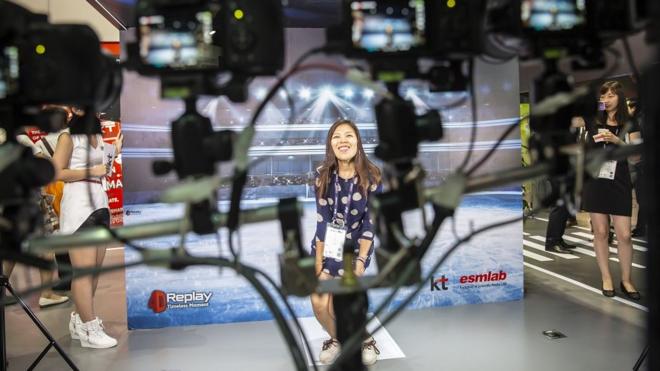 An attendant has her picture taken by a 360 degree surround ca,era system at the Mobile World Congress Shanghai in Shanghai, China, on Wednesday, June 29, 2016. (photo by Qilai Shen/In Pictures via Getty Images)