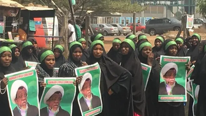 IMN members wit dia placards