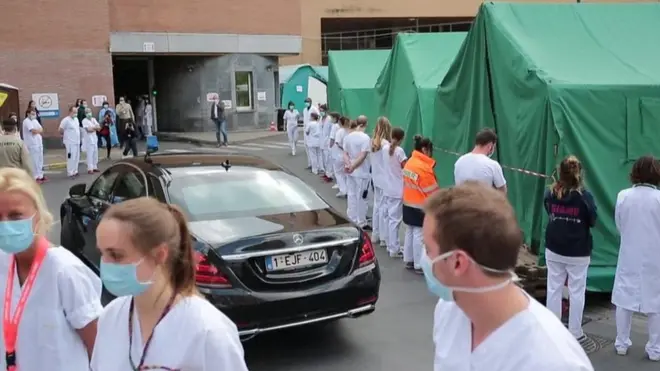 Hospital staff turn their backs