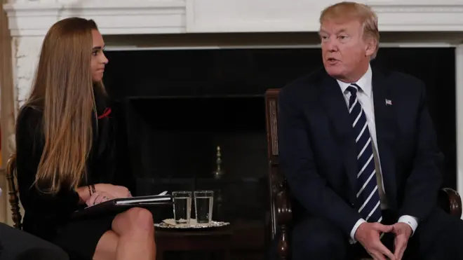 Marjory Stoneman Douglas High School shooting surviving student Julia Cordover (L) listens to US President Donald Trump