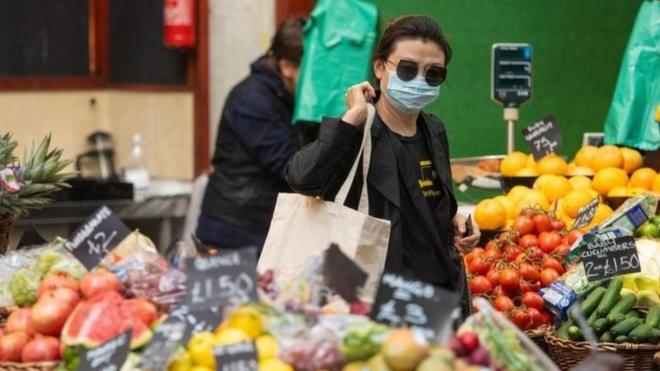 A shopper wearing a protective face mask at Borough Market, in London