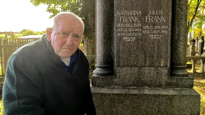 Michael standing at the cemetery where his family are buried