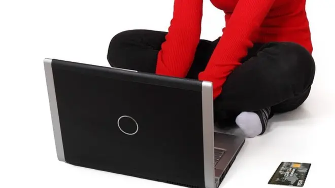 Person wey dey press computer.