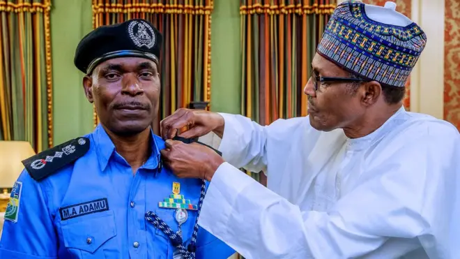 President Buhari decorate di new Inspector-General of Police, Abubakar Mohammed Adamu Tuesday afternoon for Aso rock.