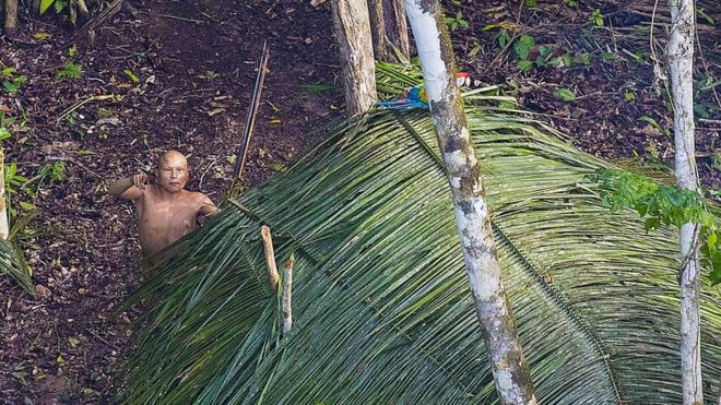 Indígena olha para helicóptero