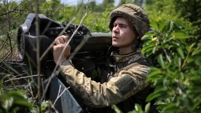 A Ukrainian service member holds a next generation light anti-tank weapon at a position on the front line, near Bakhmut, Donbas region