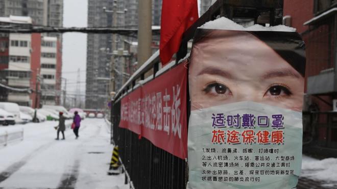 A poster advising about measures to protect from the coronavirus is seen at the entrance to a residential compound in Beijing