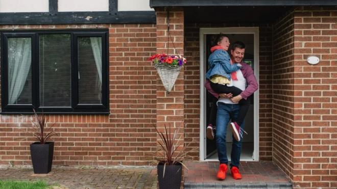 Man leaves his house with his child