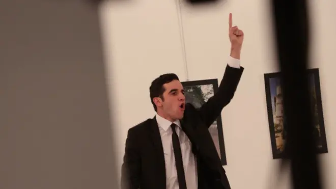 Burhan Ozbilici dari balik tembok mengambil foto pria yang menembak dubes Rusia untuk Turki.