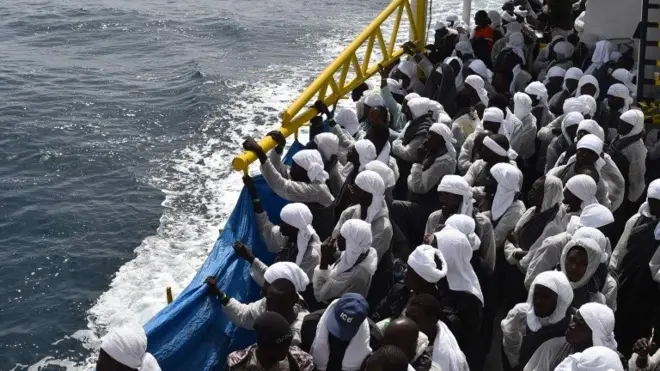 Migrants wait aboard rescue ship "Aquarius" as they arrive in the port of Cagliari, Sardinia