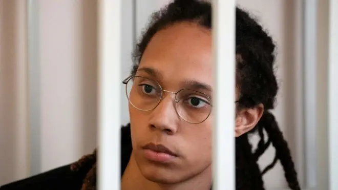 Brittney Griner sits in a defendant's cage ahead of Wednesday's proceedings in her drug possession trial in Russia
