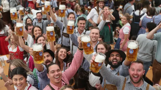 Visitors celebrate in a beer tent at the opening day of the 2018 Oktoberfest beer festival on September 22, 2018 in Munich, Germany.