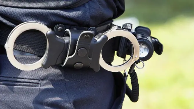 Law & Order, Police officers belt wit handcuffs.