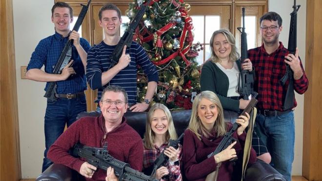 Rep Thomas Massie and his family bearing a collection of military-style assault rifles