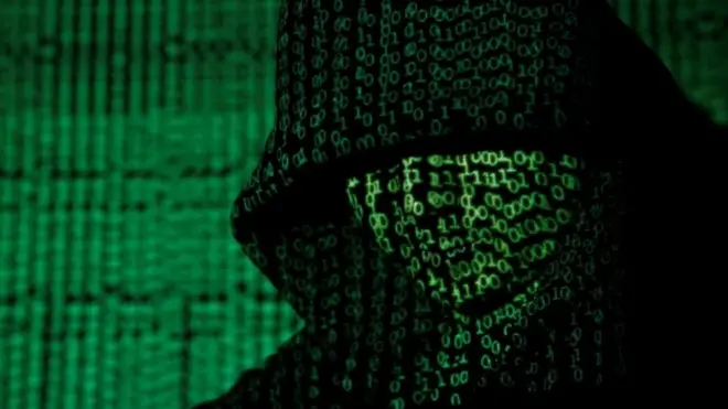 Projection of cyber code onto a hooded man