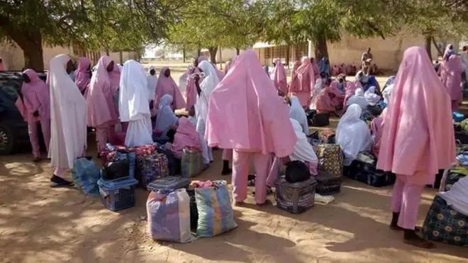 students for Dapchi girl's secondary school stand with dia load after di attack