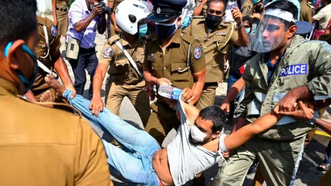 A Frontline Socialist Party (FSP) activist is taken into police custody during a protest against the brutal murder of George Floyd, an African-American man who died in Minneapolis after a policeman kneeled on his neck for several minutes, Colombo on June 9, 2020. - Sri Lanka June9 broke up a protest organised in solidarity with the Black Lives Matter campaign over the death of African American George Floyd at the hands of US police. Police arrested at least 10 activists of the Frontline Socialist Party (FSP) as they tried to take out a march and demonstrate outside the US embassy in Colombo. (Photo by LAKRUWAN WANNIARACHCHI / AFP) (Photo by LAKRUWAN WANNIARACHCHI/AFP via Getty Images)