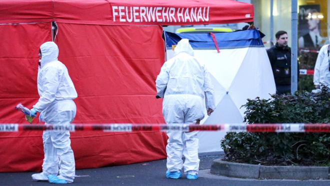 Forsenic Police work near at the crime scene after two shootings in Hanau